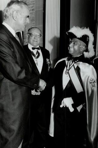 Lieutenant-Governor Henry Jackman greets Pat Rodrigues, a member of the Knights of Columbus, at Queen's Park