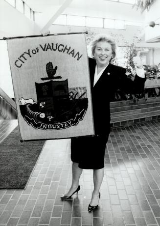 Proud Mayor: Vaughan Mayor Lorna Jackson displays the sign declaring her once-rural municipality: now with 104:000 people: the first city in York Region