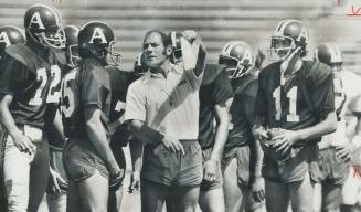 It's this way, fellas, Toronto Argonauts head coach Russ Jackson holds up sheet from club's play book at yesterday's workout to newest quarterbacks in(...)