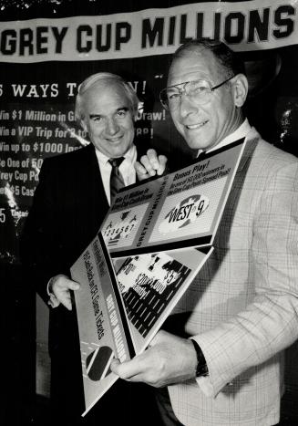 Pick a winner, Former CFL great Russ Jackson and league commissioner Doug Mitchell, left, display oversized tickets of Ontario's newest lottery, Grey Cup Millions