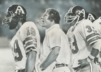 Biggest improvement in 1975 Argonauts will be the coaching staff according to Star football writer Al Sokol, Russ Jackson, middle, with players Zenon (...)