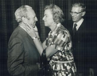 Norman James, who retired this week after 40 years as a Toronto Star photographer, is greeted by columnist Lotta Dempsey at a goin-away party given by friends