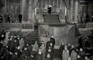 Heads bowed, members of the Japanese parliament listen while Emperior Hirohito reads an Imperial decree at the opening session of the diet in the Hous(...)