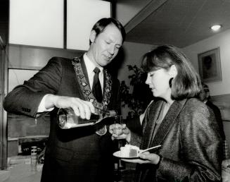 3.55. East York Mayor Dave Johnson pours on the charm for Turner, who by this time has had her fill of New Year's levees