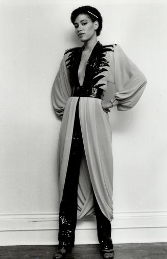 Left, she models low-cut saffron color dress trimmed in black sequins and worn over narrow black sequined pants