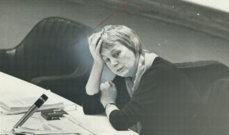 Alderman Anne Johnston. Plowing through sheafs of reports