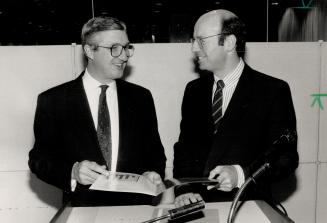 David Jolley, publisher and president of The Toronto Star, left, confers at the annual meeting with David Galloway, president of Torstar Corp. Below is chairman Beland Honderich