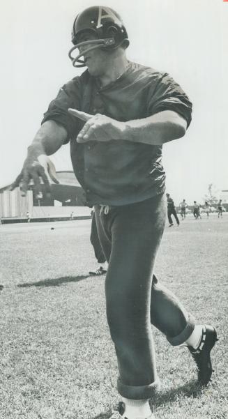 The newcomer. Top passer in Continental League for several years, Don Jonas is learning intricacies of Canadian football. Rival Tom Wilkinson is helping him