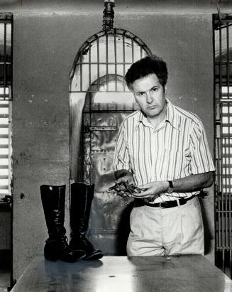 Murder memories: Reporter Jones in the old Oxford County Jail, where Birchall was hanged, with Birchall's gun and wore to the swamp: [Incomplete]