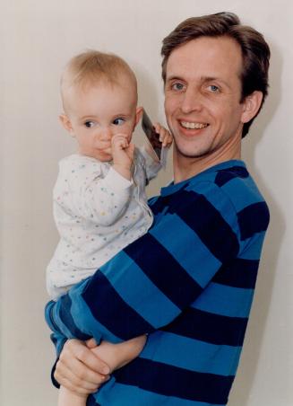 Bundle of joy: Canadian actor Robert Joy, in town filming the sci-fi movie Millennium, proudly presents his 11-month-old daughter, Ruby