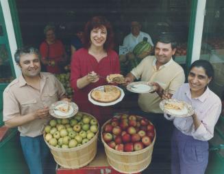 Piece of the pie: Kensington Market merchants, from left, Manuel Mendonca, Abel Gouveia and Tanoo Desai, share apple pie with Star food editor Marion Kane