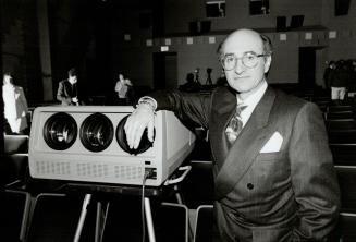 Executive showtime: President Allen Karp demonstrates a projector to show slides or videos to business meetings in Toronto Cineplex Odeon theatres