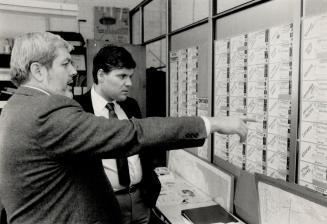 Pro-life lobbyist, Jim Hughes, whose group supported Karygiannis, shows him the board where his group records all candidates' positions on the abortion issue