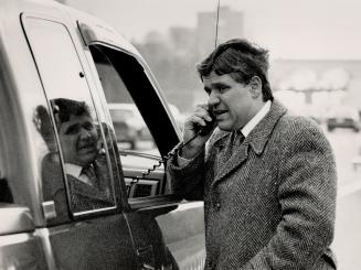 After an accident on the Don Valley Parkway, Karygiannis uses a tow-truck telephone to call police