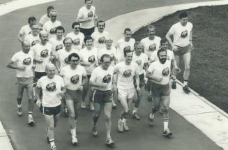 Setting a hot pace: Dr. Terry Kavanagh, third from left on the front row, leads members of the Toronto Rehabilitation Centre's long-distance club on a(...)