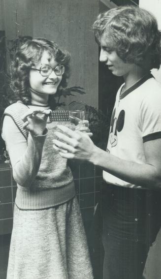 Karen Kay 14, a Maurice D'amore, 22 of Weston, chinking their ginger ale glasses celebration drink