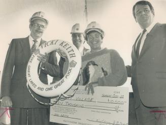 Vicki honored. Swimmer Vicki Keith accepts a donation for Variety Village from Penta Stolp executives, from left, vice-president Christopher Mullin, president Harry Stolp and chairman John Overzet