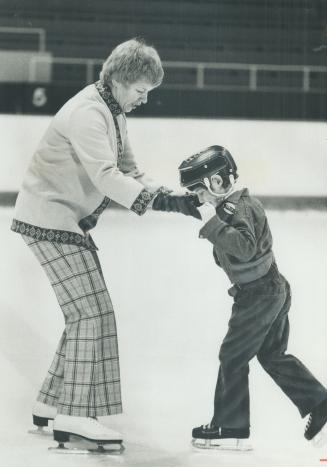 Teaching the blind to skate, Andra Kelly, wife of Leaf coach Red Kelly, coaxes 7-year-old Paul Legare (top) to try it