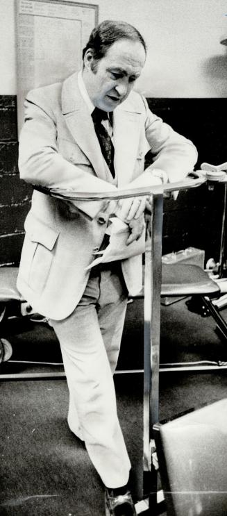 Tortured face of Leafs coach Leonard (Red) Kelly reflects the end of Toronto's hope for Stanley Cup this season as he leans on the exercise machine in(...)