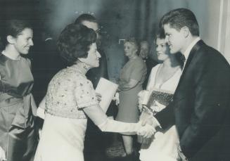 Mrs. Rose Kennedy, mother of the late U.S. president, John Kennedy, shakes hands with Justin Laurin at the King Edward Hotel as his wife Violet watche(...)