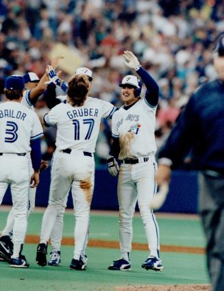 Hero's welcome: Jeff Kent, the hero in yesterday's 2-1 win, exchanges high-fives with the man he drove in, Kelly Gruber