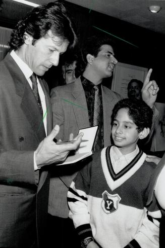 Going to bat for a cause. Imran Khan, one of the world's most popular cricket stars, signs an autograph last night for Sumair Mirza, 11, of Toronto at(...)