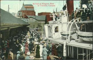 Image shows a Niagara boat full of passengers arrival at Toronto Harbour. 