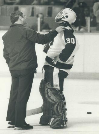 A goalle's life, II: Leafs trainer Guy Kinnear comes out on the ice at Maple Leaf Gardens to check goalie Don Edwards, who was complaining that Penguins were giving him a pain in the neck