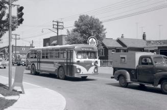 Hollinger Bus Lines, bus #84, on Woodbine Avenue, looking north east from Cosburn Avenue, Toronto, Ontario