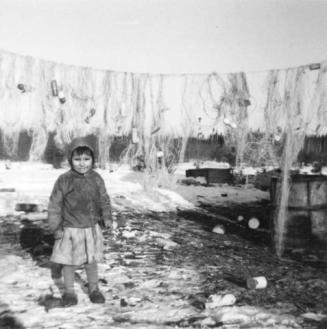Young child with drying fishing nets