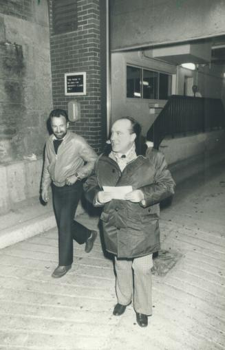 No comments: As a smiling supporter looks on outside the Toronto (Don) Jail last night, Ernst Zundel, right, holds an order forbiding him to talk or write about the Holocaust