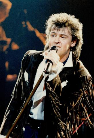 Playing the crowd: Paul Young has charisma, but the audience seems more aware of it than he is, says reviewer Stephen Ostick of the singer's concert at Maple Leaf Gardens last night