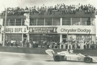 Non-paying watchers on roof outnumber paying customers as racer Michael Follett of Idaho roars by