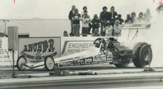 Dan Garlits takes off in cloud of smoke and spinning wheels on way to winning Top Fuel event at Dragway Park yesterday