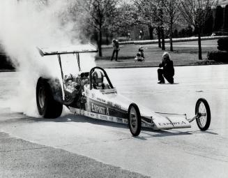 Burning rubber from rear tires of his 1,800-horse-power dragster at CNE yesterday, Gary Beck of Edmonton shows the form which he hopes will give him t(...)