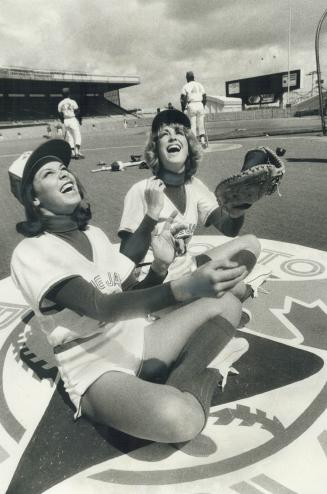 Toronto Blue Jays' new ball girls, Leslie Hughes, left, and Sara Karlsson, both 17, get into the spirit aration for today's opening game against Detro(...)