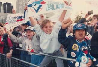 Louise Rodgers, 9, centre, and Bob Takahashi, 25, lead cheers for Jays