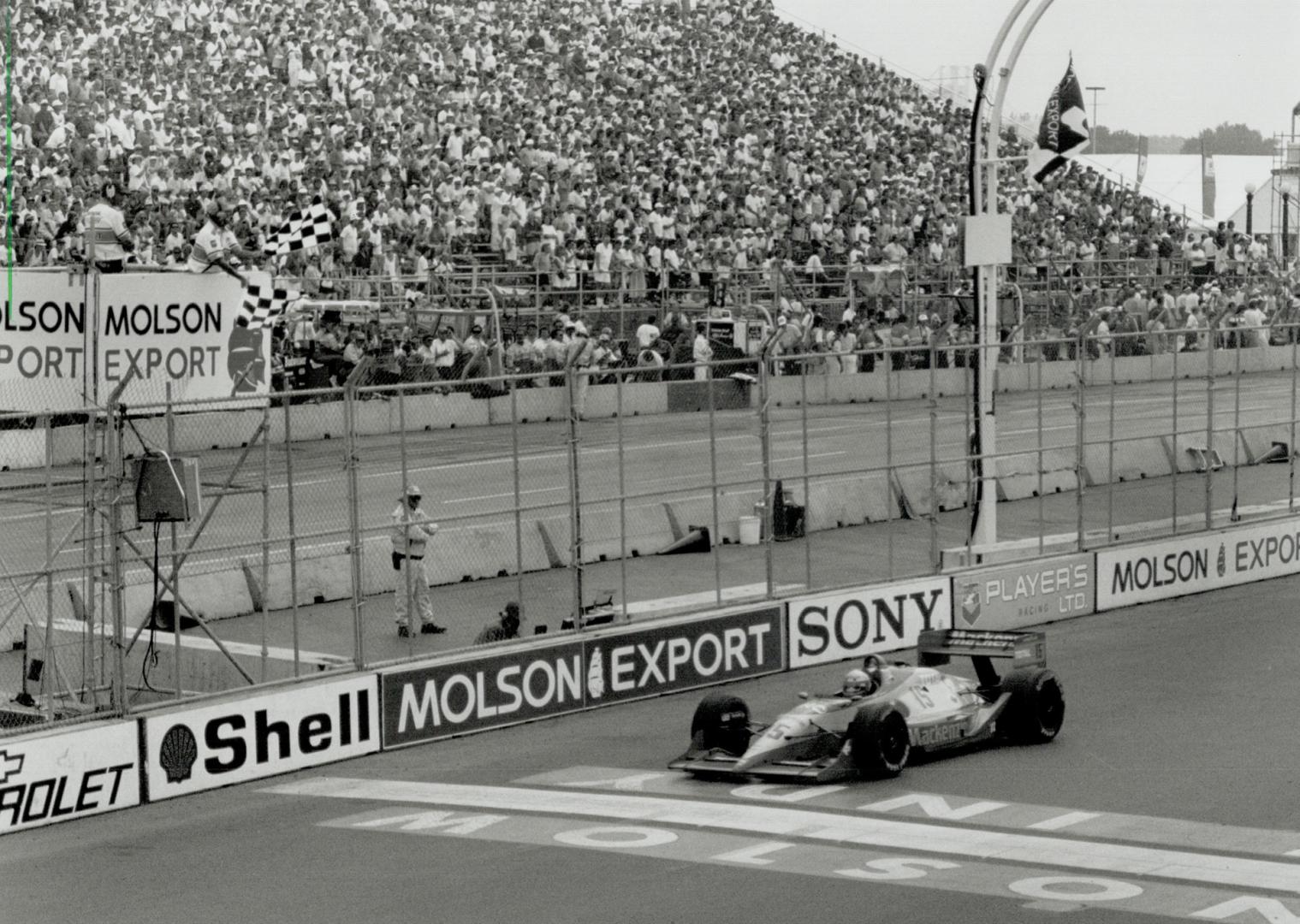 Hitting the line: Canadian Scott Goodyear takes the checkered flag for a seventh-place finish and $47,454 in prize money, matching his best Indy finish here