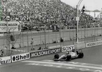 Hitting the line: Canadian Scott Goodyear takes the checkered flag for a seventh-place finish and $47,454 in prize money, matching his best Indy finish here
