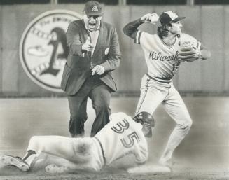 There's plenty of action here. Second base umpire Ron Luciano is at his vociferous best calling out Blue Jay's sliding Gary Woods. Robin Yount, meanwh(...)