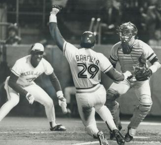 Get down! Blue Jays' on-deck hitter Lloyd Moseby, left, bellows for Jesse Barfield to hit the dirt