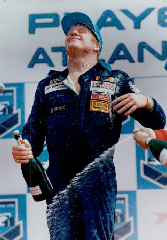 Crowing rights: Stuart Crow gets a bath from his Mumms after winning Formula Atlantic race yesterday