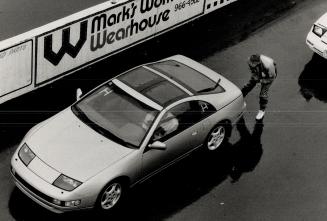 Competitor Peter Shaw (inset) chooses his mount, a '90 Nissan 300ZX, while instructor (above) helps another adjust mirrors