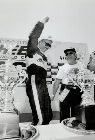 Triumph . . . R.K. Smith celebrates win in Toronto celerates win in Toronto Star endurance race at Mosport