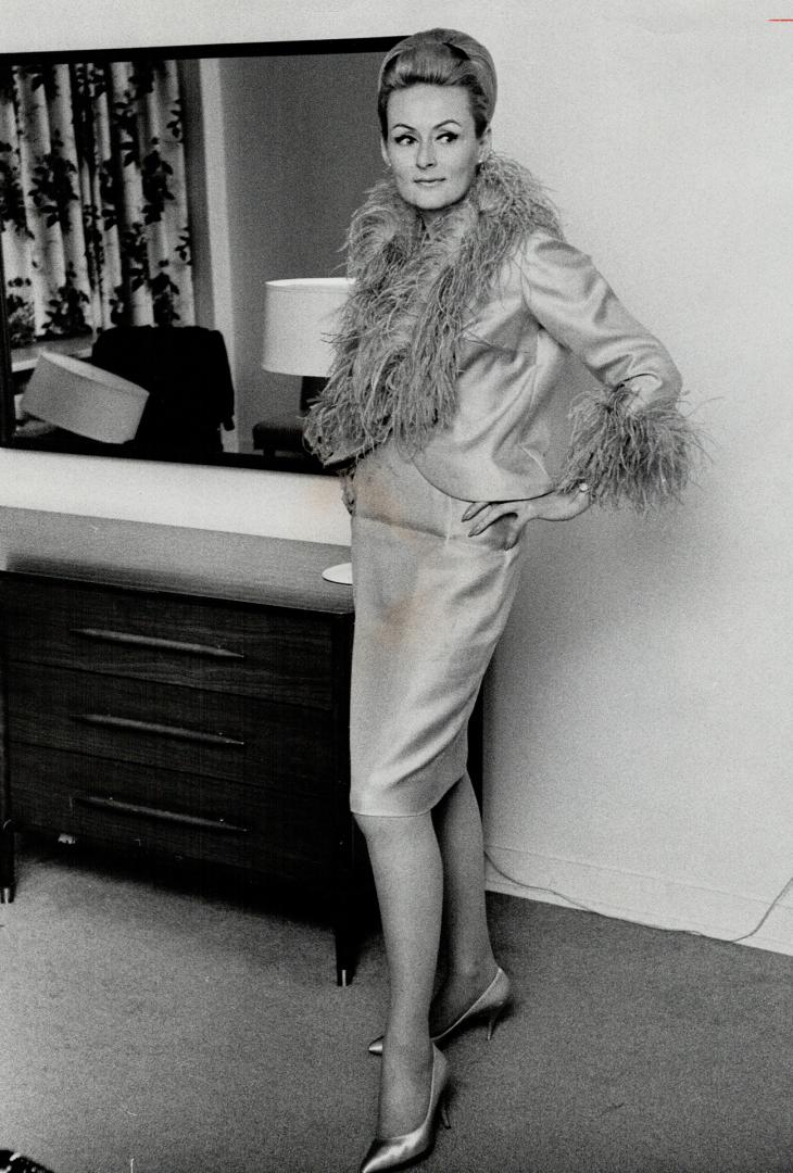 Rally driver Rosemary Smith. She designed the turquoise cocktail suit she wears