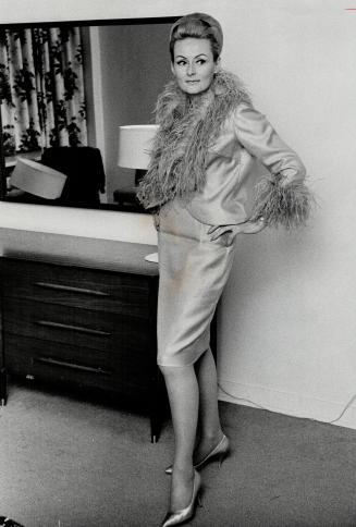 Rally driver Rosemary Smith. She designed the turquoise cocktail suit she wears