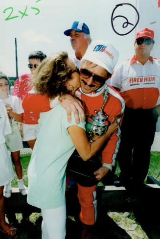 Victory kiss: A fan gives U.S. driver R.K. Smith a peck on the cheek after his team's Corvette won The Toronto Star 24-hour race yesterday at Mosport