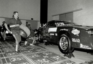 Dress rehearsal: Dave Sandford, left, and Terry Constantin demonstrate a pit stop yesterday on driver Ken Wilden's Camaro at a Molson Indy news conference