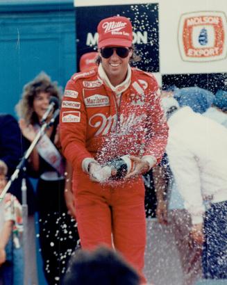 Champagne shower: Danny Sullivan, runner-up to Emerson Fittipaldi in yesterday's Molson Indy at Exhibition Place, performs one of car racing's rituals by spraying the crowd with champagne