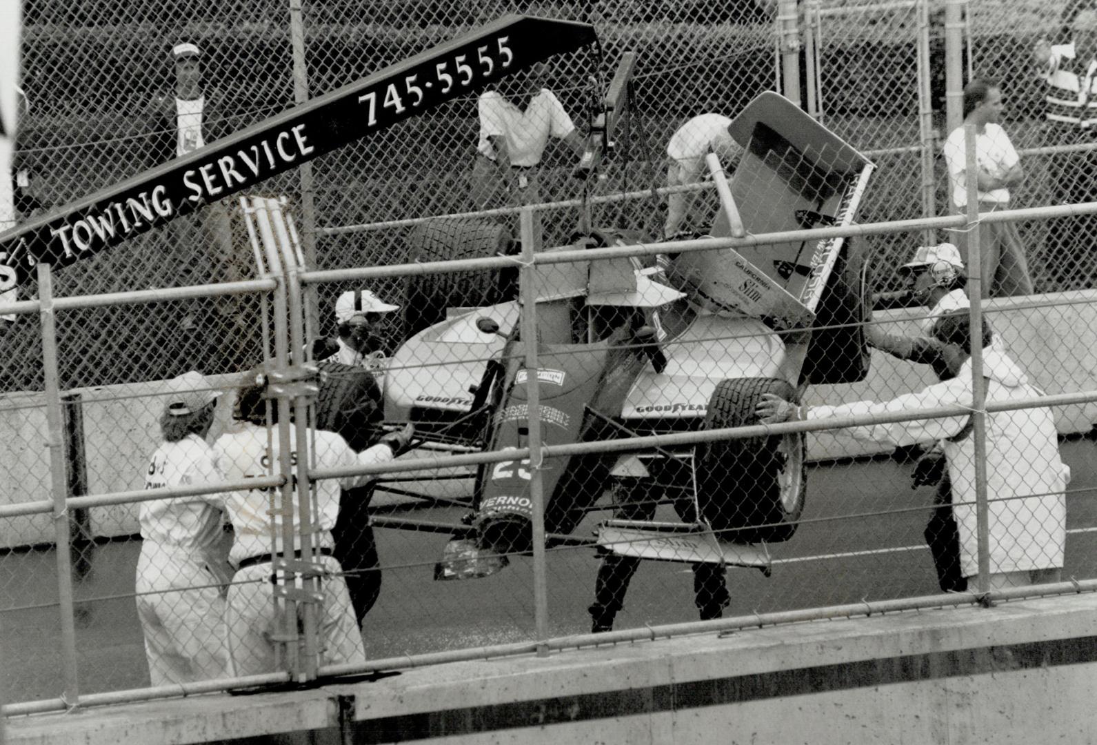 Not Willy's day: Willy T. Ribbs' Lola T9000 Judd gets a tow after Ribbs, whose car is co-owned by TV star Bill Cosby, crashed out of the rain-shortened Molson Indy. Only 94 of 103 laps were run